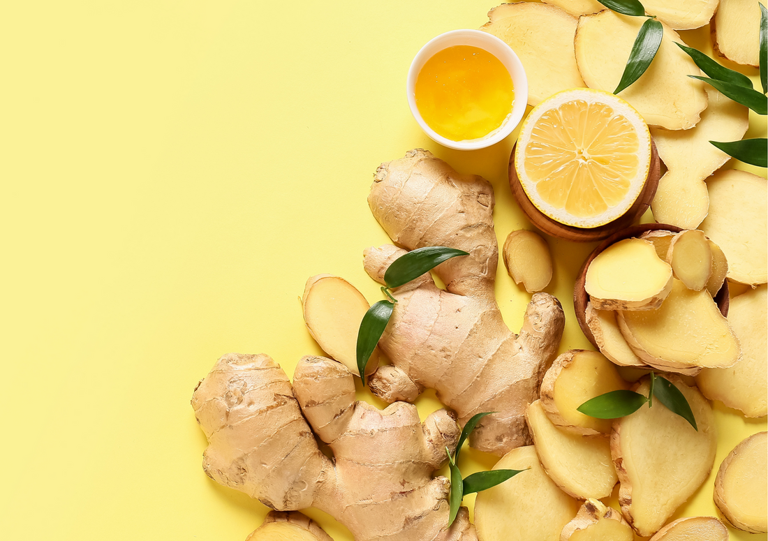 Image of ginger root pieces, cut up and laid out against a pale yellow background with lemon slices